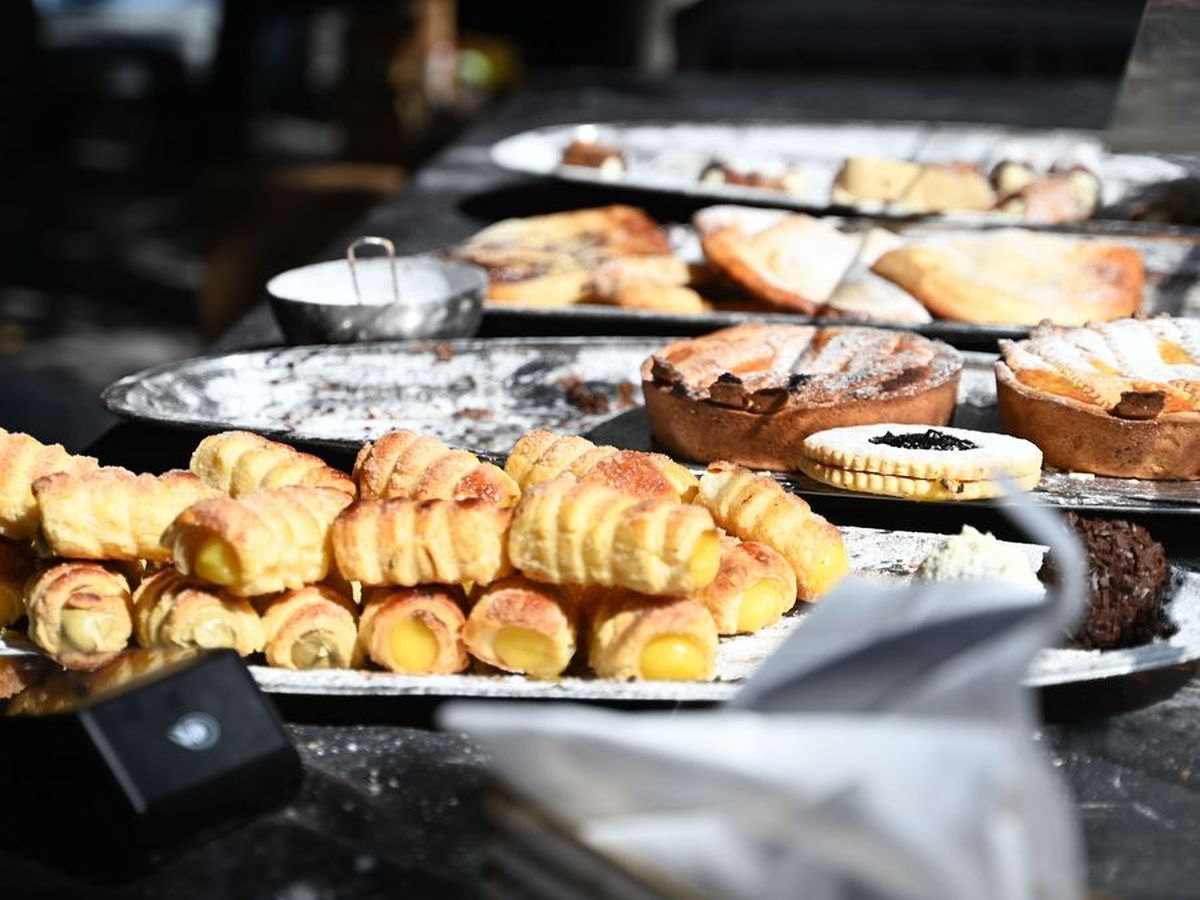Trays of cannoli, crostata and Italian pastries on a market counter