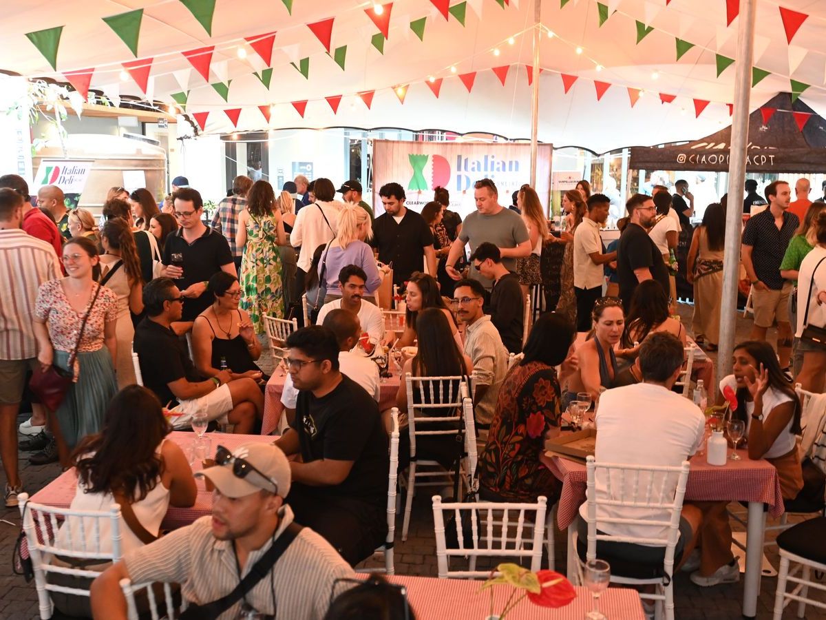 Long communal tables under red, white and green bunting