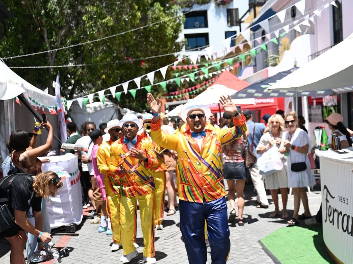 A roaming band in bright yellow suits performing down the street