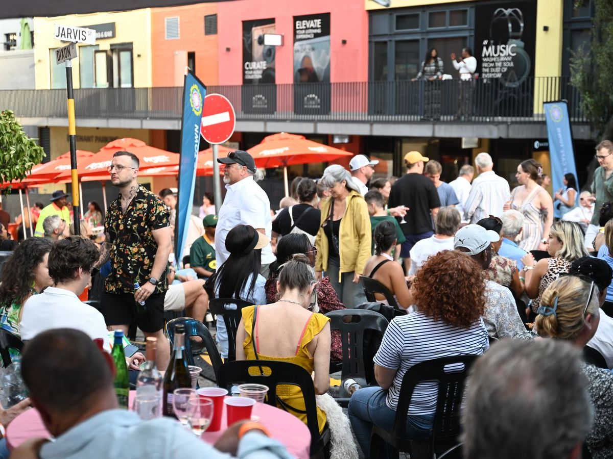 Crowds filling the street beneath the festival banners