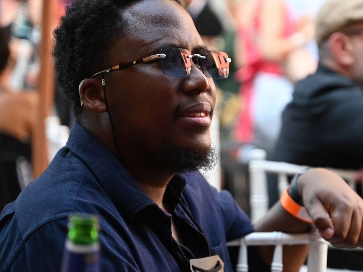 A festival-goer wearing a branded Italy in Town tasting glass on a lanyard