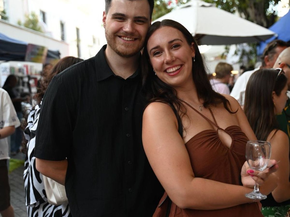 A couple sitting together at a festival table
