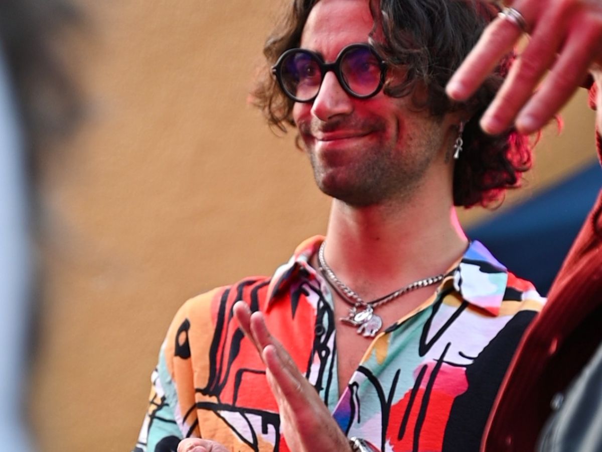 A festival-goer in a bright patterned shirt in the evening light