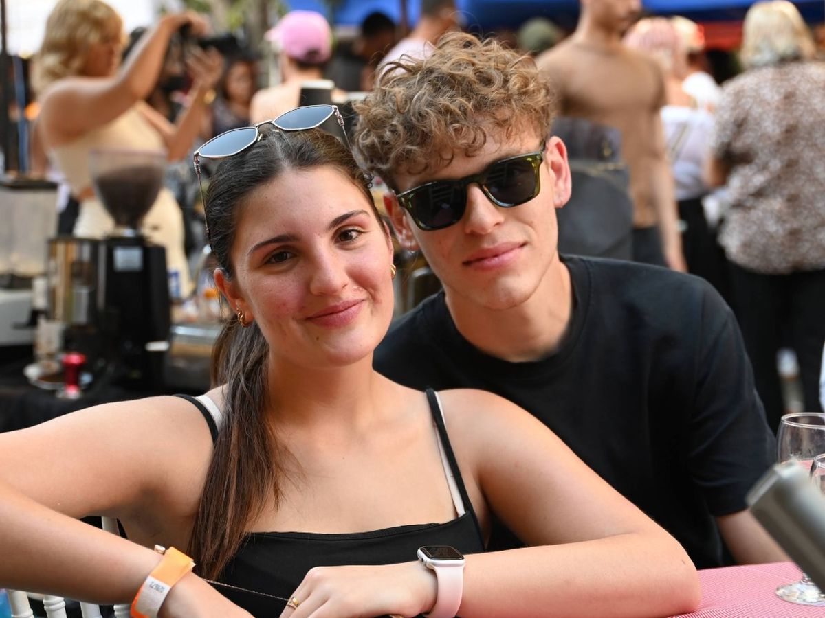 Two festival-goers seated together at a table